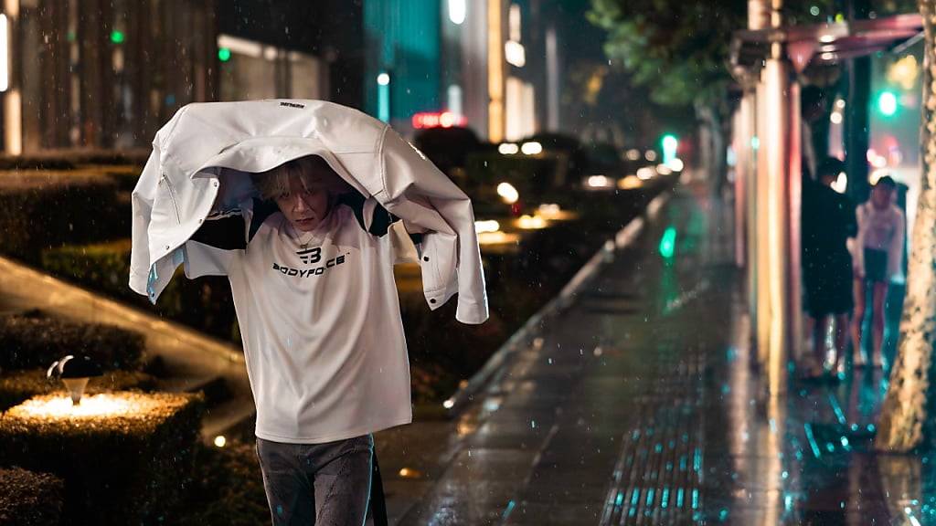 Ein Mann läuft durch die Strassen von Shanghai, während der Taifun «Bebinca» heftige Regenfälle verursacht.