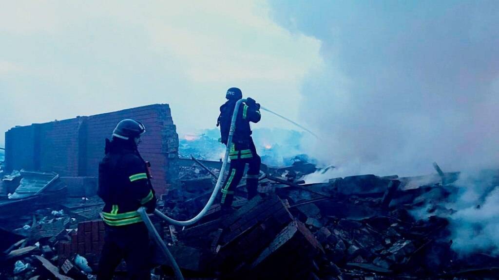 HANDOUT - Auf diesem vom ukrainischen Katastrophenschutz zur Verfügung gestellten Foto löschen Rettungskräfte ein Feuer in einem Wohnhaus, das nach einem Angriff zerstört wurde. Foto: Uncredited/Ukrainian Emergency Service/AP/dpa - ACHTUNG: Nur zur redaktionellen Verwendung im Zusammenhang mit der aktuellen Berichterstattung und nur mit vollständiger Nennung des vorstehenden Credits