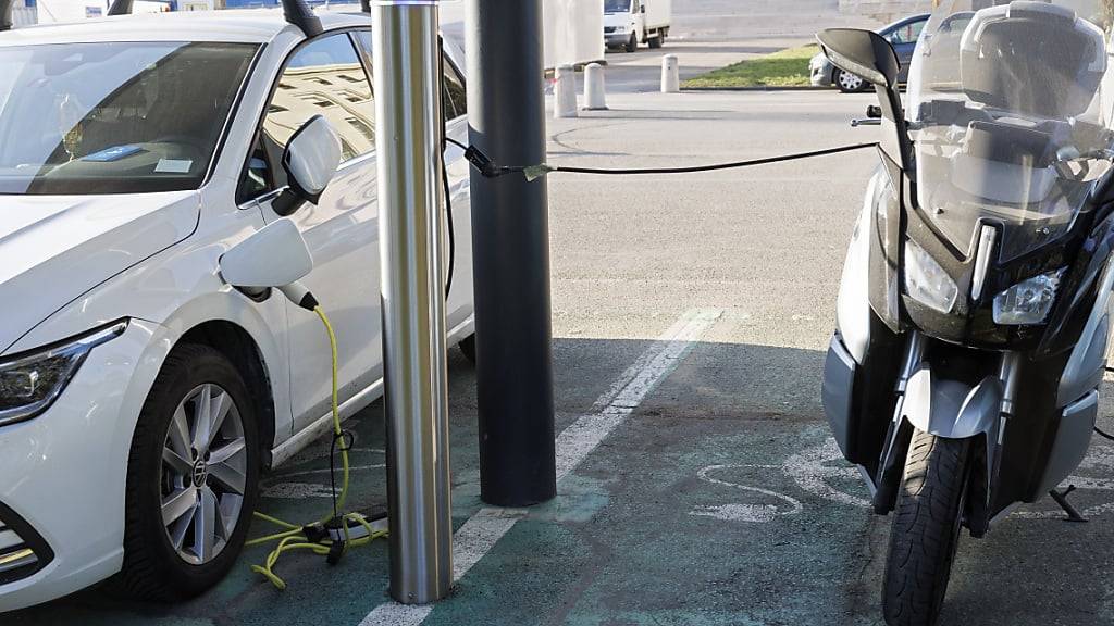Ein Auto und ein Motorrad mit Elektroantrieb an einer Zapfsäule. (Archivaufnahme)