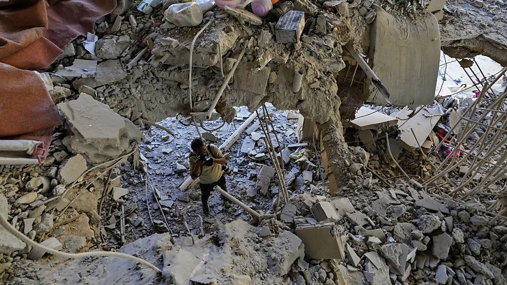 dpatopbilder - Ein Fotograf dokumentiert die Schäden in einem Gebäude, das von einem israelischen Luftangriff in einem südlichen Vorort von Beirut getroffen wurde. Foto: Hassan Ammar/AP/dpa