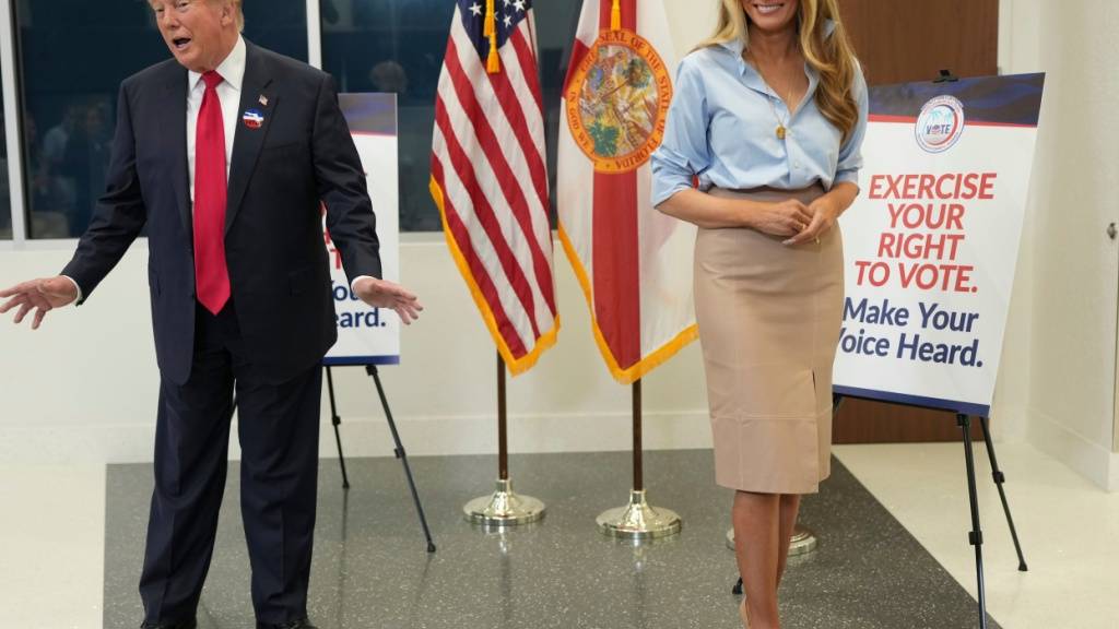 US-Präsident Donald Trump spricht an der Seite von First Lady Melania Trump, nachdem er seine Stimme abgegeben hat. Foto: Mark Schiefelbein/AP/dpa
