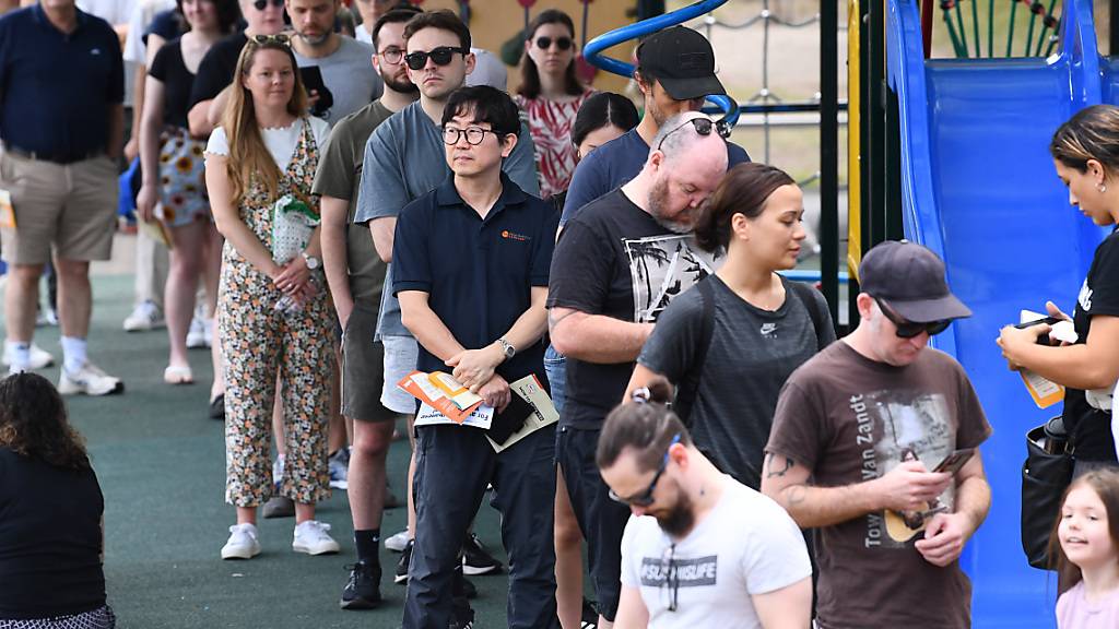 Voters stand in line at a voting centre in West End, inner Brisbane, Saturday, October 14, 2023. Australians will vote in a referendum on October 14 on whether to enshrine an Indigenous voice in the country's constitution. (AAP Image/Jono Searle) NO ARCHIVING