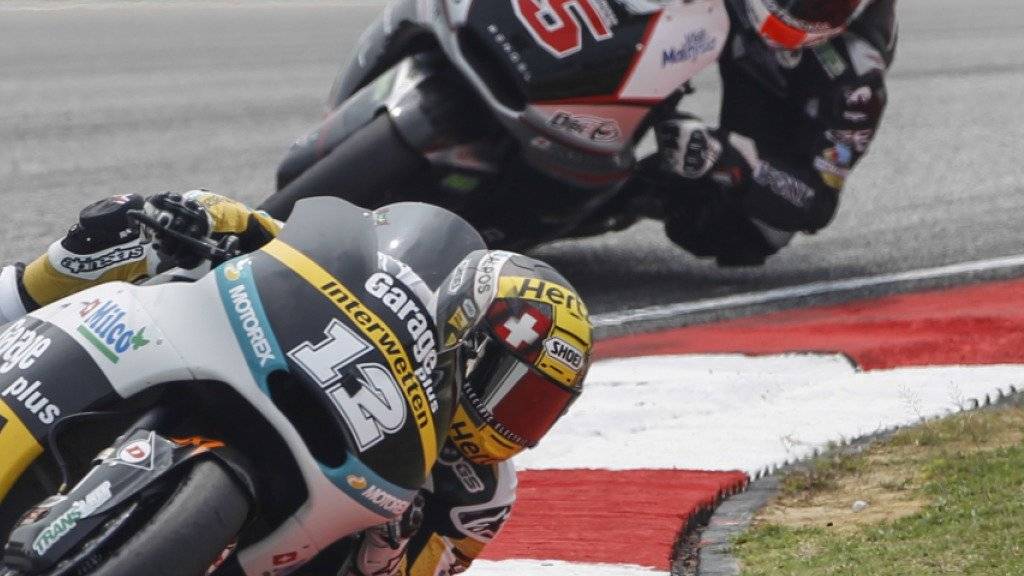 Moto2 rider Thomas Luethi, left, of Switzerland steers his Kalex in front of Johann Zarco of France during the Malaysian Motorcycle Grand Prix in Sepang, Malaysia, Sunday, Oct. 25, 2015. (AP Photo/Joshua Paul)