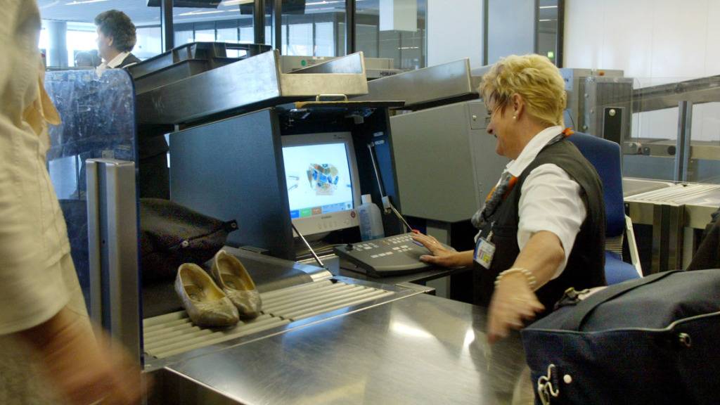 Eine Angestellte der Luftsicherheit kontrolliert Handgepäck am Flughafen in Frankfurt. (Archivbild)