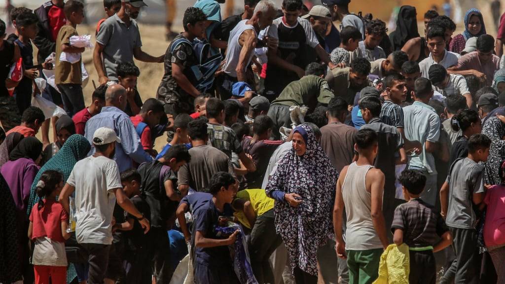 Palästinenser beeilen sich, die über dem Gazastreifen abgeworfenen humanitären Hilfsgüter einzusammeln. Foto: Abed Rahim Khatib/dpa