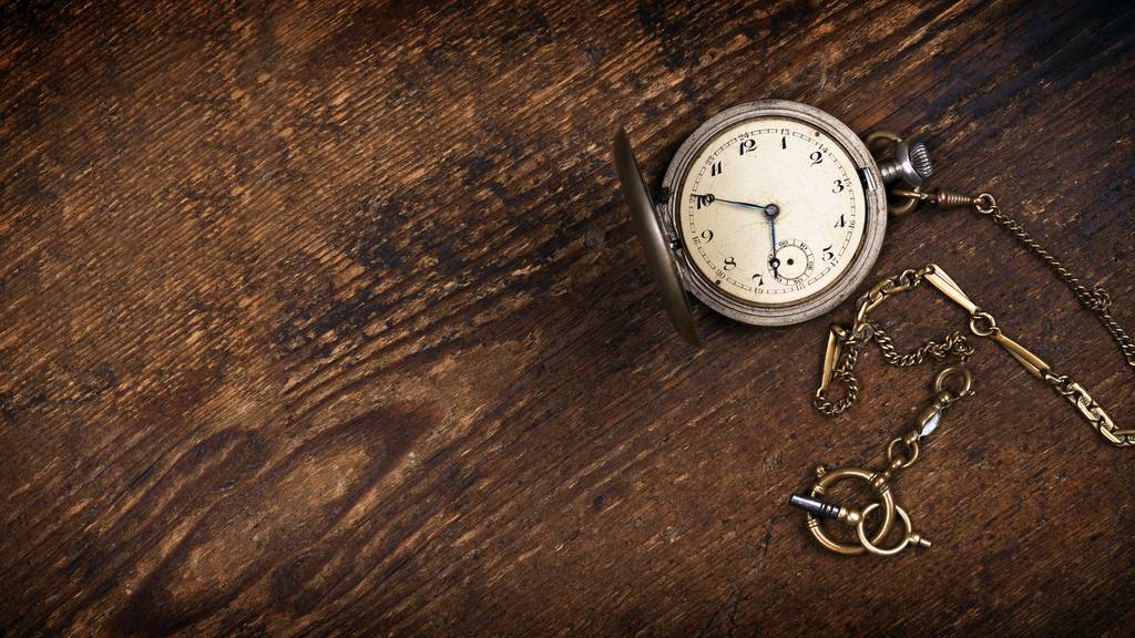 Vintage pocket watch on wooden table