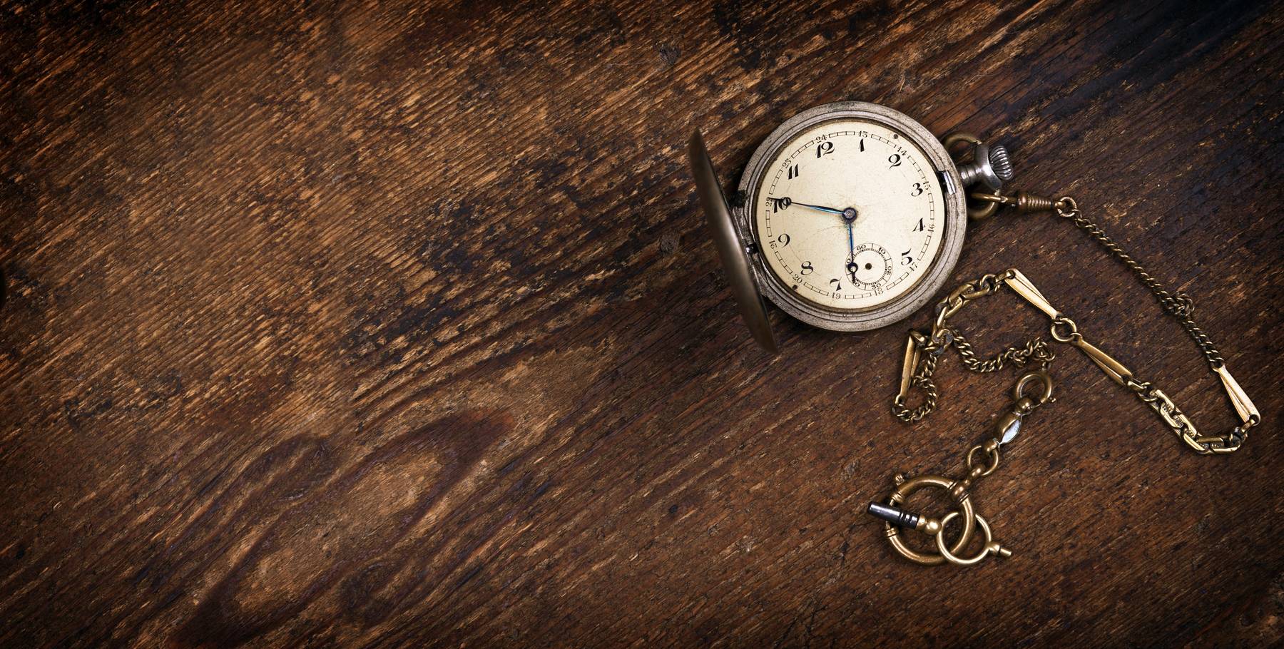 Vintage pocket watch on wooden table