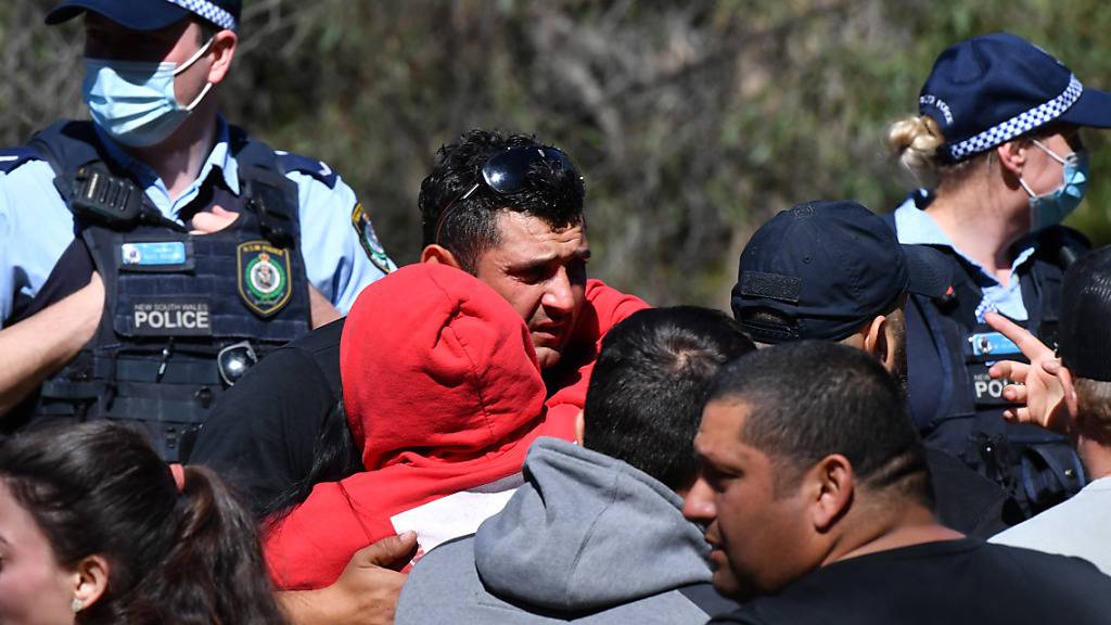 Anthony Elfalak, the father of 3 year old missing boy AJ Elfalak, hugs family and friends when they learn AJ has been found alive on the family property near Putty south west of Sydney, Monday, September 6, 2021. Three year old AJ  has been missing for 4 days with a massive search effort being launched by NSW Police, SES and the RFS.(AAP Image/Dean Lewins) NO ARCHIVING