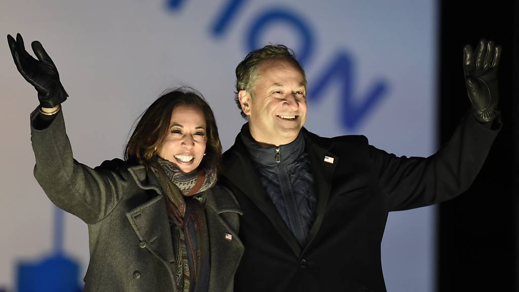 ARCHIV - Kamala Harris, «Gewählte Vizepräsidentin» («Vicepresident-elect»), und ihr Ehemann Doug Emhoff winken Unterstützern während einer Wahlkampfveranstaltung. Foto: Michael Perez/AP/dpa