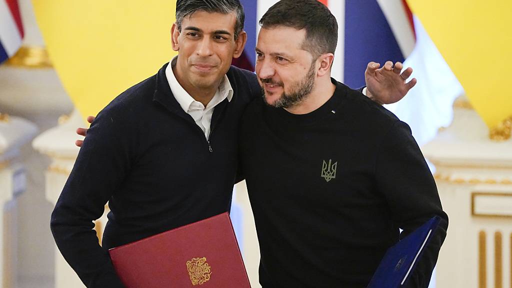 dpatopbilder - Rishi Sunak (l) umarmt Wolodymyr Selenskyj nach der Unterzeichnung der Dokumente. Foto: Efrem Lukatsky/AP/dpa