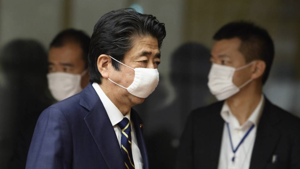 Shinzo Abe, Ministerpräsidenten von Japan, kommt zu einer Pressekonferenz und trägt einen Mundschutz. Japan hebt den Corona-Notstand in den meisten Landesteilen vorzeitig auf. Abe gab diese Entscheidung nach Beratungen mit Experten bekannt. Ausgenommen sind städtische Grossräume wie Tokio und Osaka.
