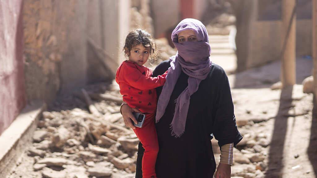 Nach dem schweren Erbeben in Marokko steht eine Frau mit ihrer Tochter vor ihrem Haus südlich von Marrakesch. Foto: Mosa'ab Elshamy/AP/dpa