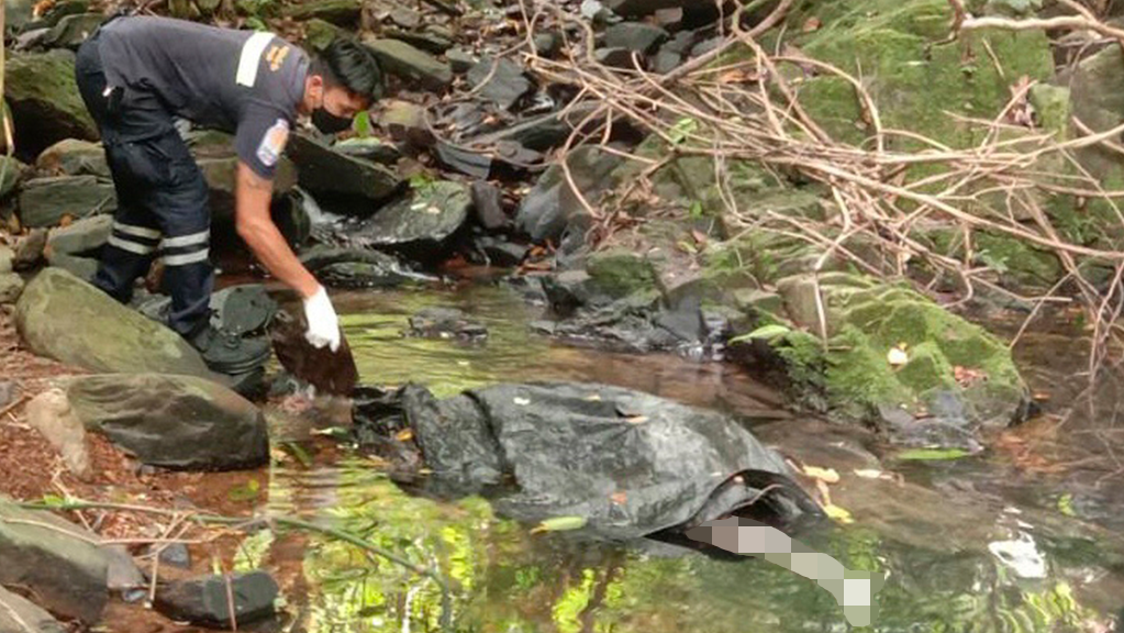 An officer inspects the spot where a Swiss woman was found dead in Phuket on Thursday, Aug. 5, 2021. Thai police are investigating after the body of a foreign woman was found at a secluded spot on the southern island of Phuket on Thursday. Thai media, quoting police, said the dead woman was a 57- year-old Swiss national.