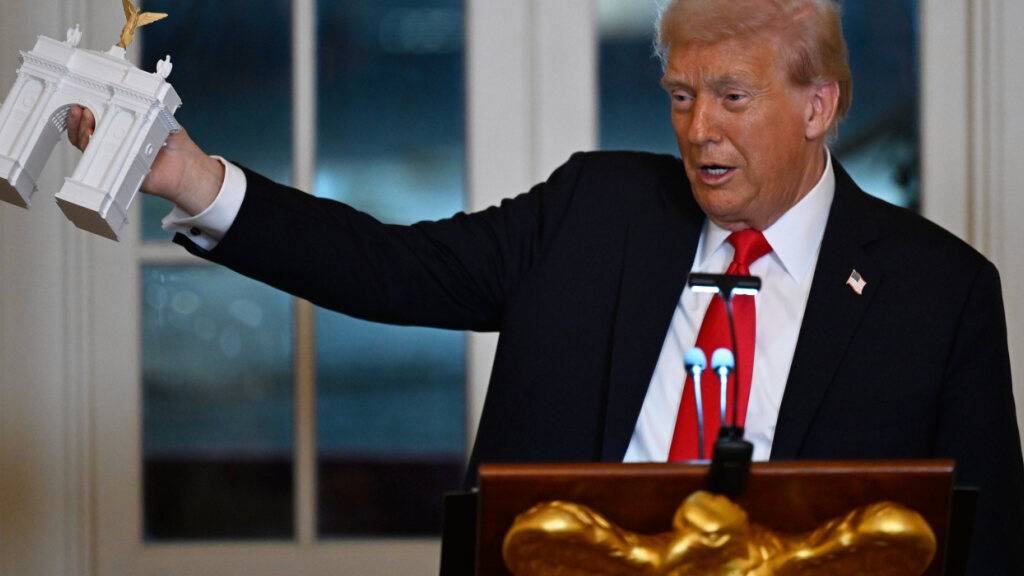 dpatopbilder - US-Präsident Donald Trump zeigt bei einem Abendessen für Spender, die zum Bau des neuen Ballsaals im Weißen Haus beigetragen haben, das Modell eines Triumphbogens. Foto: John McDonnell/AP/dpa