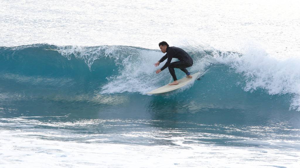 Japan Japanese man surfing. In Shikoku and Tokushima.