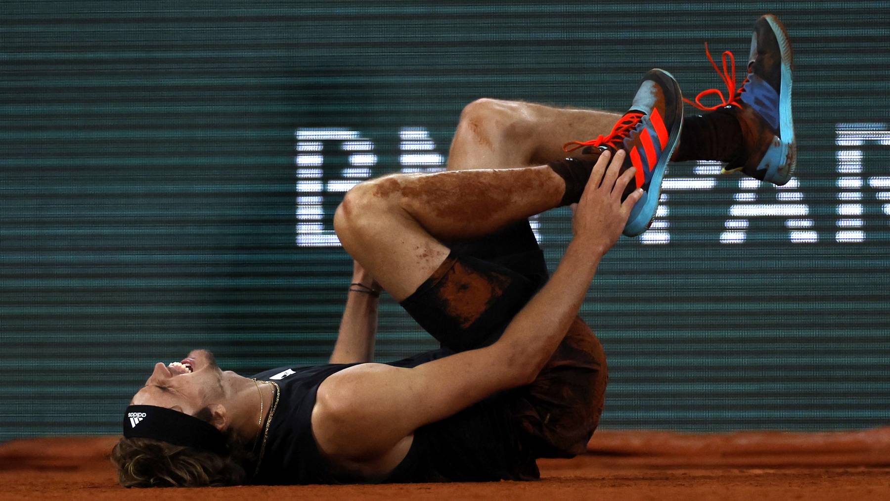 Alexander Zverev of Germany is injured on the court after falling in the men's semi-final match against Rafael Nadal of Spain during the French Open tennis tournament at Roland &#x200b;Garros in Paris, France, 03 June 2022.