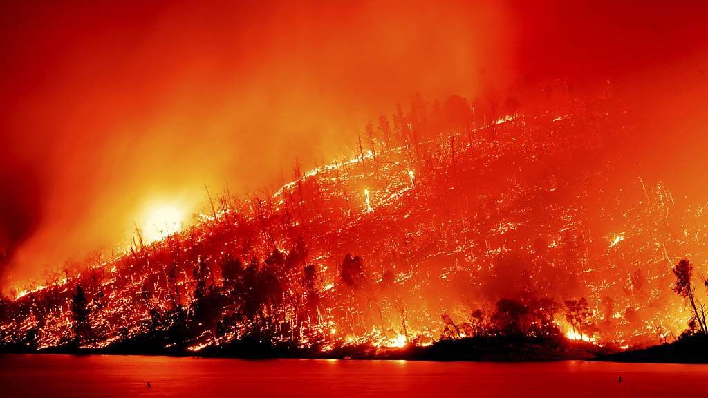 ARCHIV - Das Thompson Fire brennt oberhalb des Lake Oroville. Foto: Noah Berger/AP/dpa