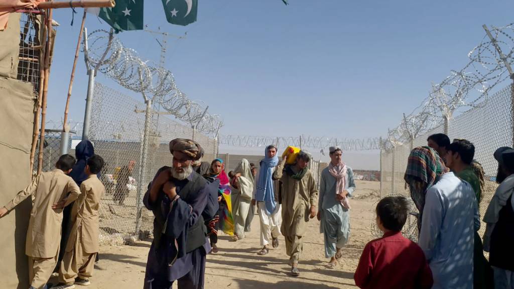 Menschen aus Afghanistan reisen am Grenzübergang Chaman, Pakistan, nach Pakistan ein. Foto: Jafar Khan/AP/dpa