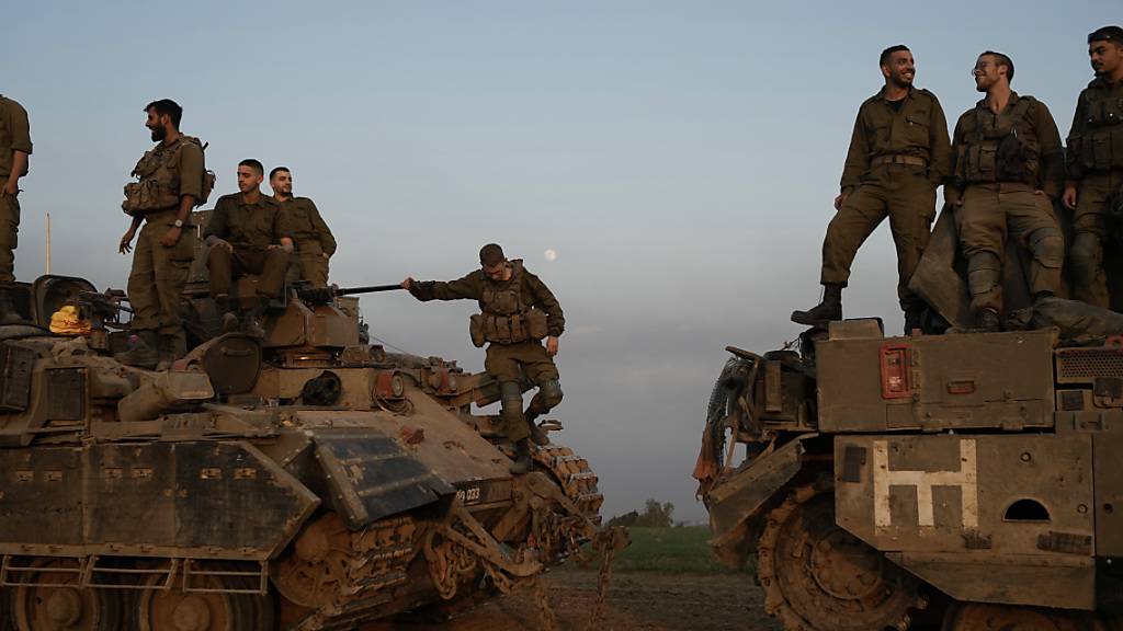 Israelische Soldaten stehen auf gepanzerten Mannschaftstransportwagen (APC) in der Nähe der Grenze zwischen Israel und dem Gazastreifen im Süden Israels. Foto: Leo Correa/AP/dpa
