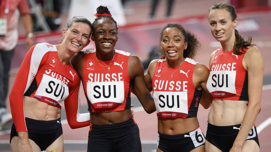 From left, Lea Sprunger, Yasmin Giger, Rachel Pellaud and Silke Lemmens of Switzerland react after crossing the finish line in the women's athletics 4x400m relay heat at the 2020 Tokyo Summer Olympics in Tokyo, Japan, on Thursday, August 05, 2021.