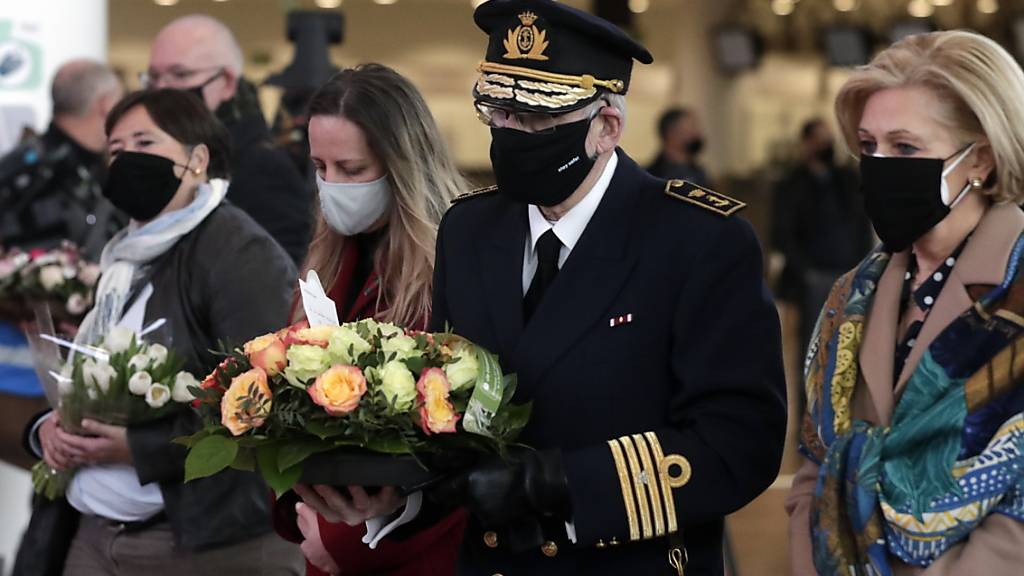Opfer und Angehörige bringen Blumen bei einer Zeremonie am Brüsseler Flughafen in Zaventem zum Gedenken an die Terroranschläge 2016. Foto: Pool Stephanie Lecocq/BELGA/dpa