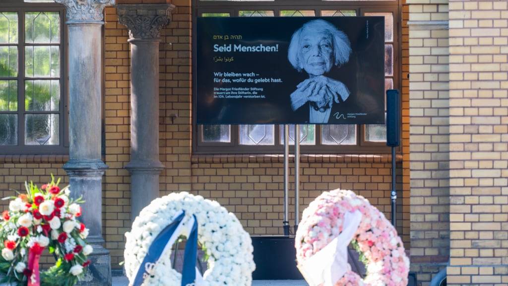 dpatopbilder - Am Tag der Beisetzung der Holocaust-Überlebenden Margot Friedländer stehen Kränze und ein Bild von Friedländer auf dem Jüdischen Friedhof Weißensee. Friedländer war am vergangenen Freitag im Alter von 103 Jahren gestorben. Foto: Christophe Gateau/dpa