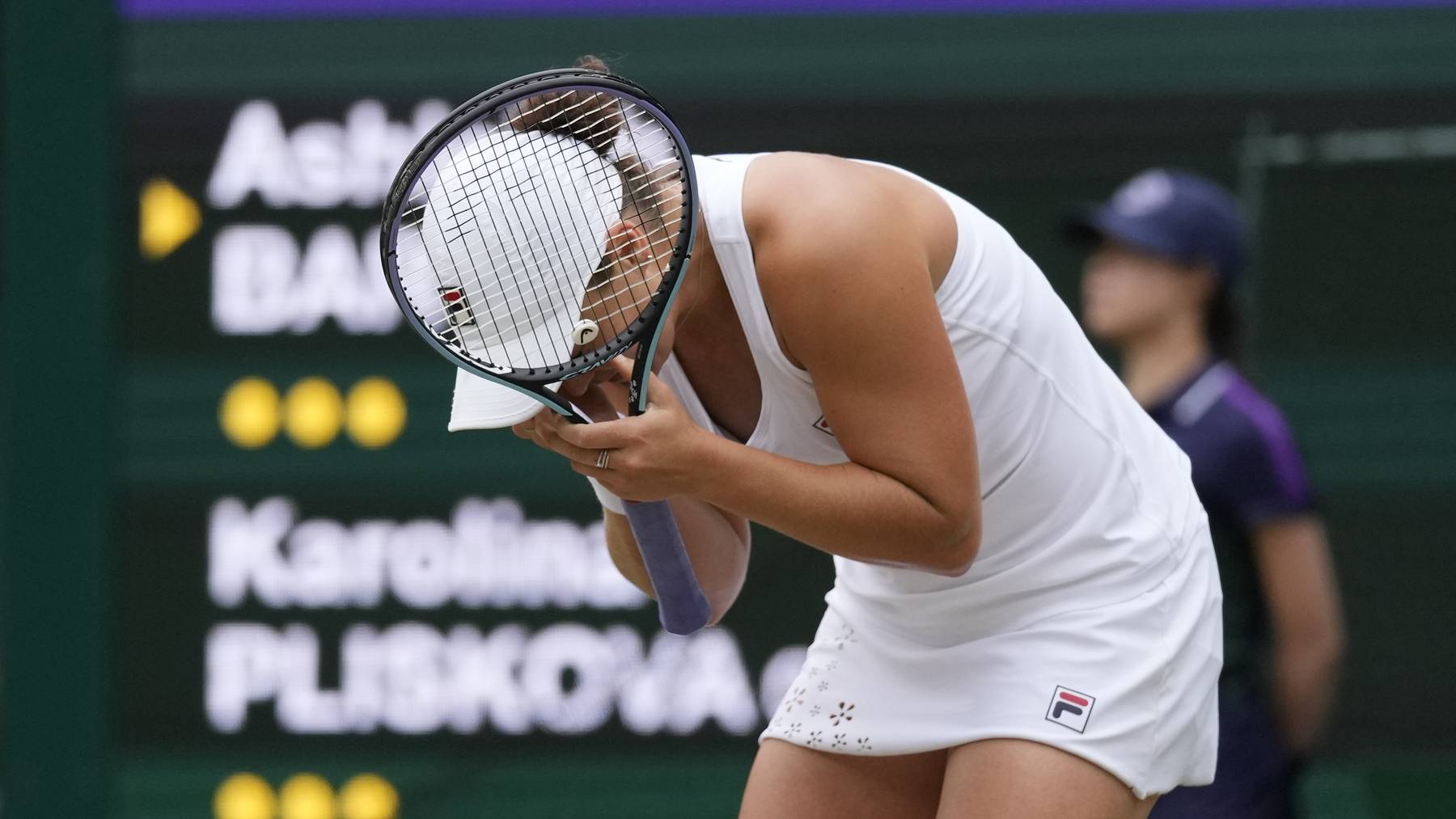 Australia's Ashleigh Barty reacts after defeating the Czech Republic's Karolina Pliskova in the women's singles final on day twelve of the Wimbledon Tennis Championships in London, Saturday, July 10, 2021. 