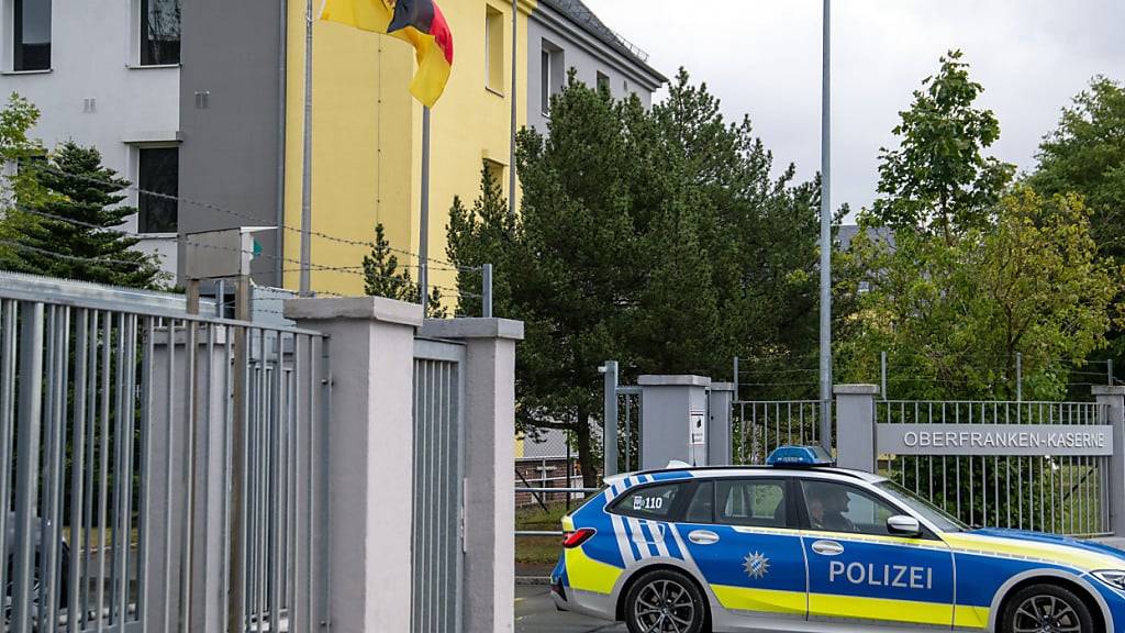 Ein Polizeiauto fährt aus der Einfahrt der Oberfranken-Kaserne. Foto: Pia Bayer/dpa