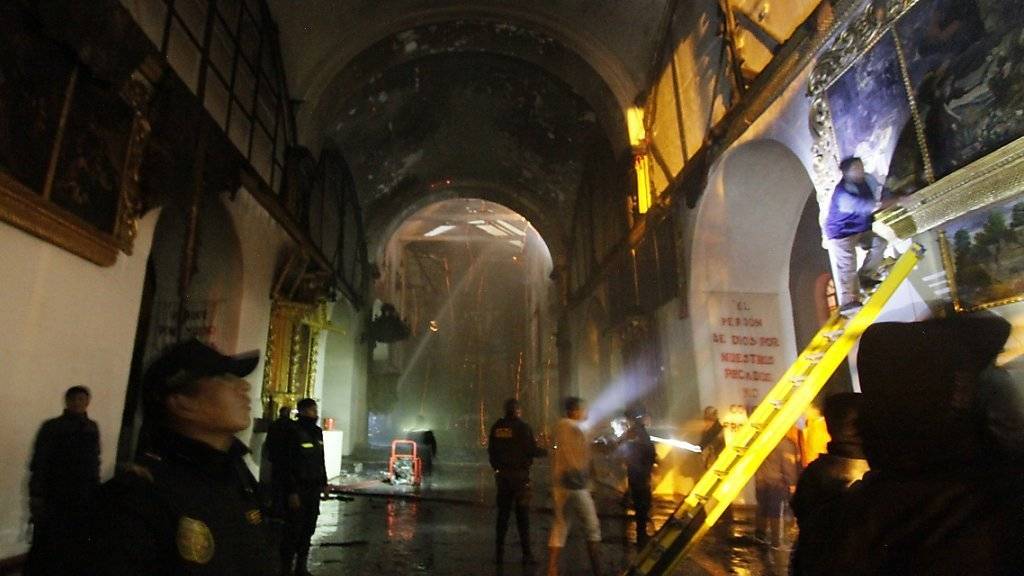 Feuerwehrleute kämpfen gegen die Flammen in der Kirche zu San Sebastian im peruanischen Cusco.