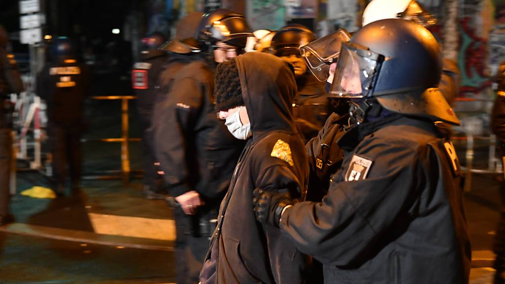 dpatopbilder - Polizisten führen in der Rigaer Straße einen Demonstranten ab, der gegen die Räumung des besetzten Hauses «Liebig 34» protestieren. Foto: Paul Zinken/dpa