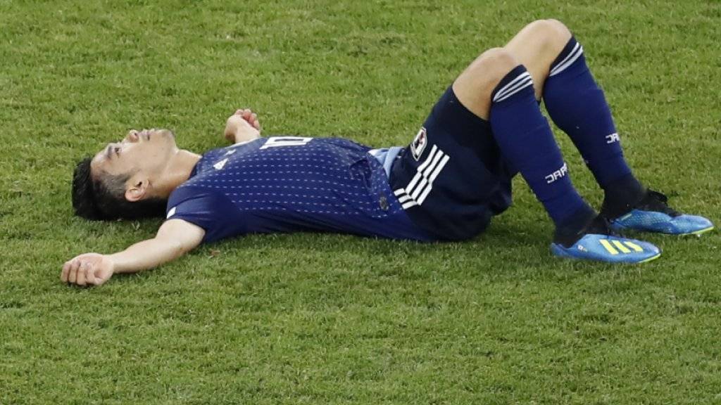 Japans Shinji Kagawa liegt nach dem Out gegen Belgien niedergeschlagen am Boden