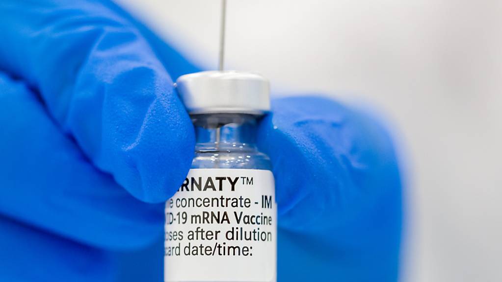 Eine medizinische Fachkraft hält ein Fläschen mit dem Pfizer-BioNTech-COVID-19-Impfstoff in der Hand.