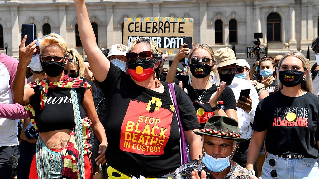 Protestors are seen during an Invasion Day rally in Brisbane, Tuesday, January 26, 2021. Australia Day 2021 has been marked by debates about changing the date or abolishing the holiday, Australia Day honours, and whether rallies should go ahead.(AAP Image/Darren England) NO ARCHIVING