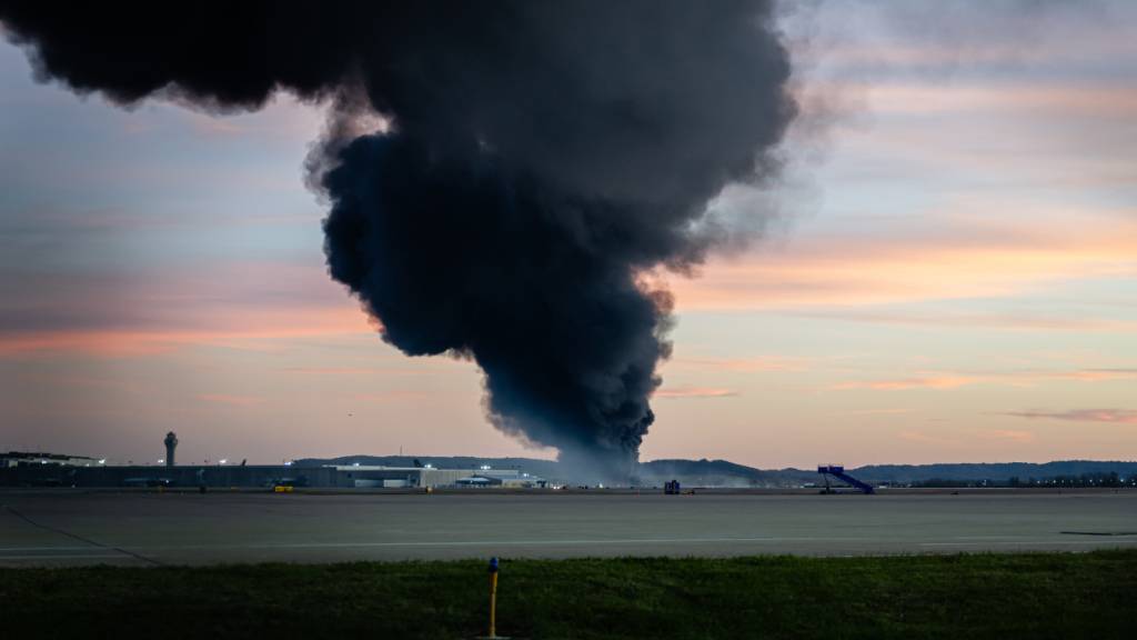Eine Rauchwolke steigt von der Absturzstelle eines UPS-Frachtflugzeugs am Louisville Muhammad Ali International Airport auf. Foto: Jon Cherry/AP/dpa