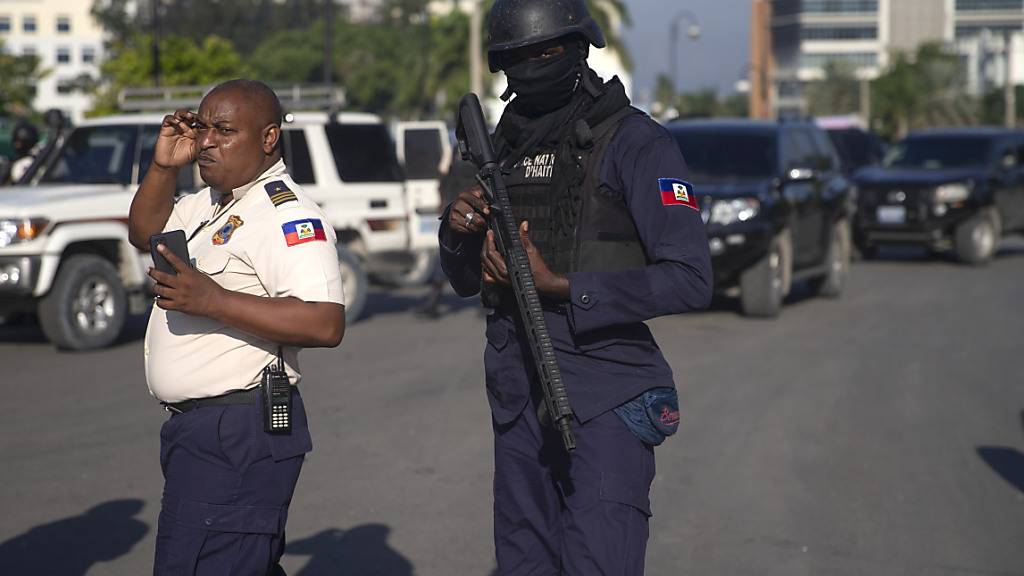 Bewaffnete Sicherheitskräfte stehen auf einer Straße in Port-Au-Prince. Foto: Joseph Odelyn/AP/dpa