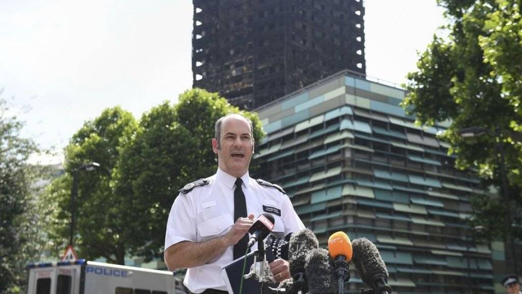 Die Zahl der Toten nach dem Hochhausbrand von London ist möglicherweise fast doppelt so hoch wie bisher angenommen.Vermutlich seien 58 Menschen bei dem Unglück am Mittwoch gestorben, sagte Stuart Cundy von Scotland Yard. Im Hintergrund die Brandruine.