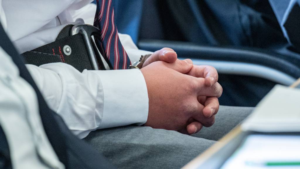 Der Beschuldigte sitzt mit Handschellen im Verhandlungssaal des Landgerichts. Foto: Armin Weigel/dpa