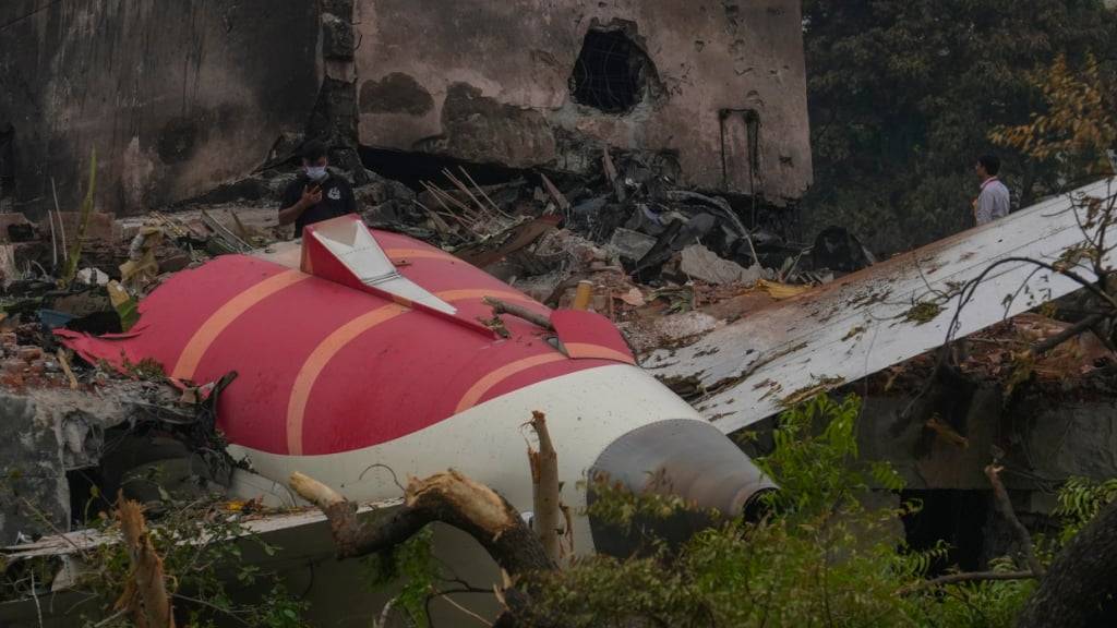 Teile eines Air India-Flugzeugs, das am Donnerstag abgestürzt ist, sind auf einem Gebäude in Ahmedabad, Indien, zu sehen. Foto: Rafiq Maqbool/AP/dpa