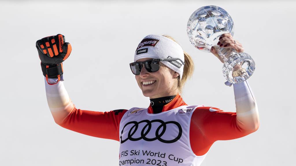 Lara Gut-Behrami of Switzerland celebrates with the women's super-g overall leader crystal globe trophy in the finish area during the women's super-g race at the FIS Alpine Skiing World Cup finals in El Tarter, Andorra, Thursday, March 16, 2023.