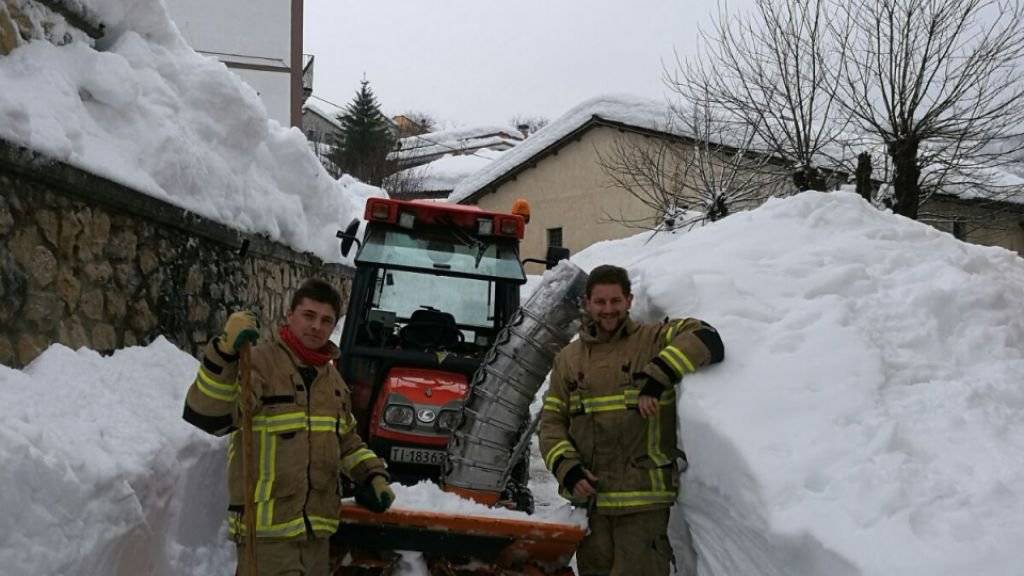 Feuerwehrmänner aus dem Tessin räumen eine Dorfstrasse in den Abruzzen.