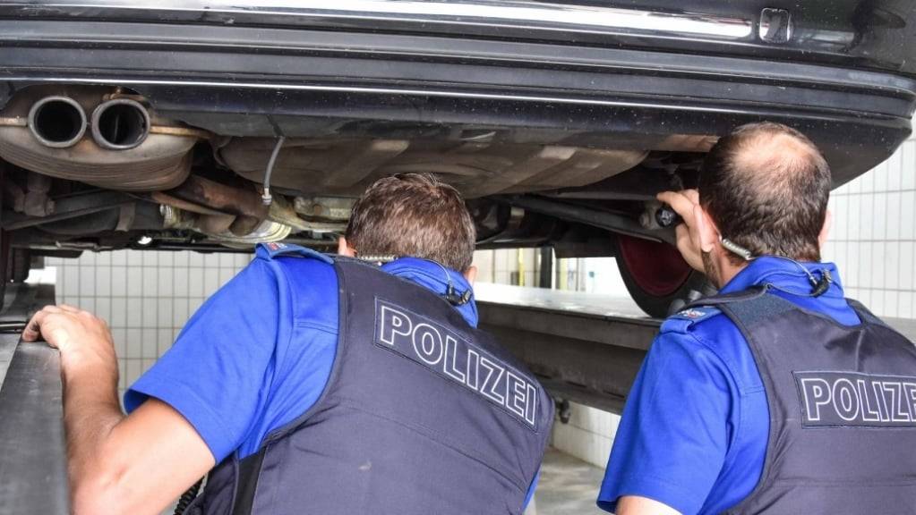 Spezialisten der Polizei bei der Untersuchung eines Fahrzeugs.