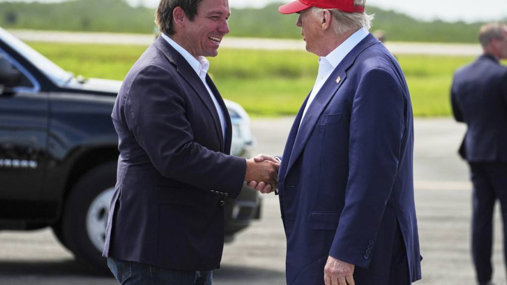 ARCHIV - Floridas Gouverneur Ron DeSentis begrüßt US-Präsident Donald Trump. Foto: Evan Vucci/AP/dpa/Archivbild