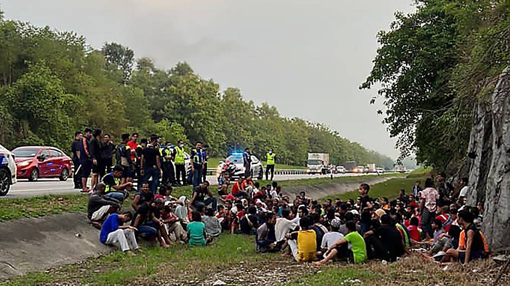 HANDOUT - Auf diesem von der Königlichen malaysischen Polizei veröffentlichten Foto hält die Polizei Rohingya-Flüchtlinge fest, die 2022 aus dem temporären Einwanderungslager Sungai Bakap geflohen waren. Foto: Uncredited/Polis Diraja Malaysia/AP/dpa