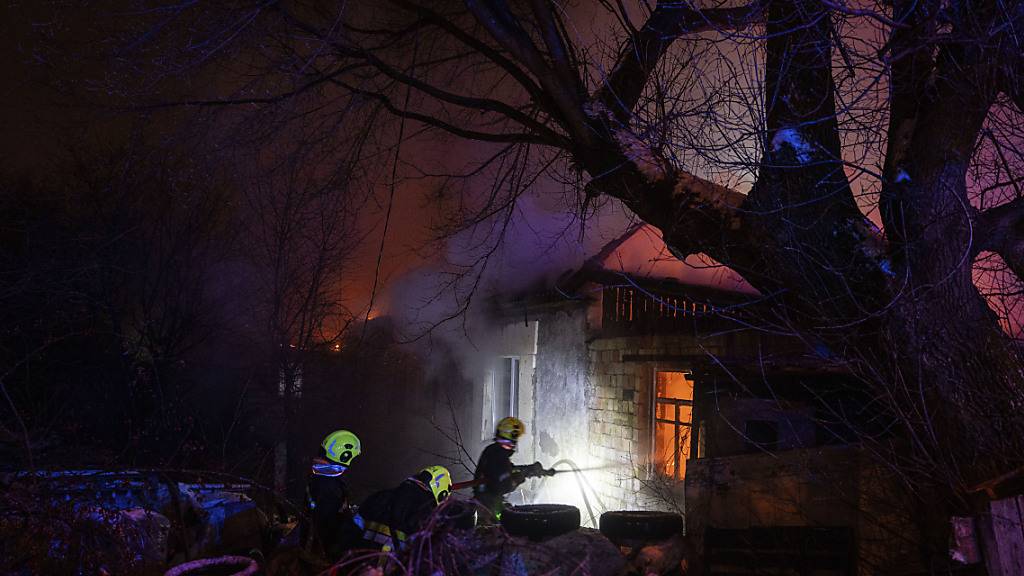 dpatopbilder - Rettungskräfte löschen ein Feuer in einem Wohnhaus nach einem russischen Raketenangriff. Foto: Evgeniy Maloletka/AP