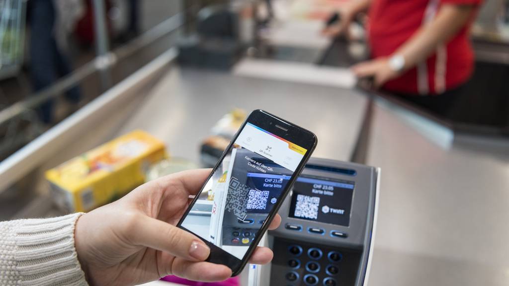 A person uses the Twint cashless payment system via Twint app at the cash register of retailer Spar in Berne, Switzerland, on May 2, 2018.