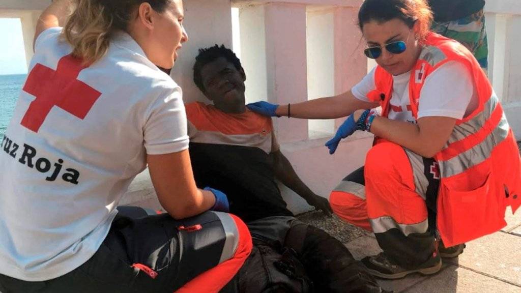 115 Flüchtlinge überwinden den Grenzzaun in Ceuta: Rot-Kreuz-Helferinnen behandeln einen von ihnen.