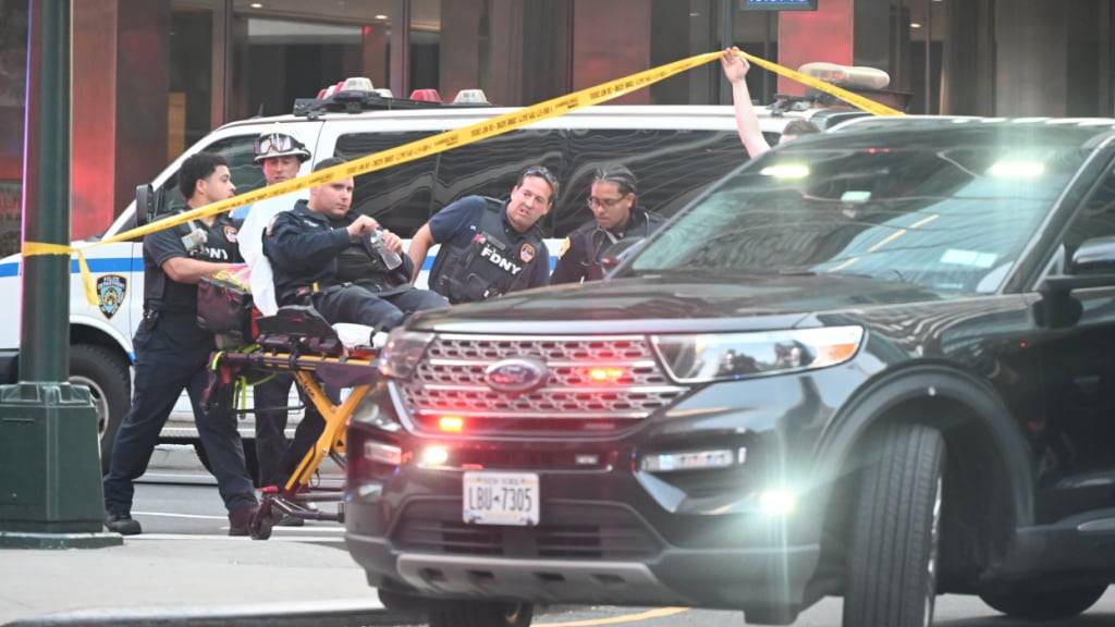 FDNY-Feuerwehrleute rollen einen Polizisten auf einer Trage, während die Polizei auf Schüsse im Stadtteil Midtown Manhattan reagiert. Foto: Kyle Mazza/TheNEWS2 via ZUMA Press Wire/dpa
