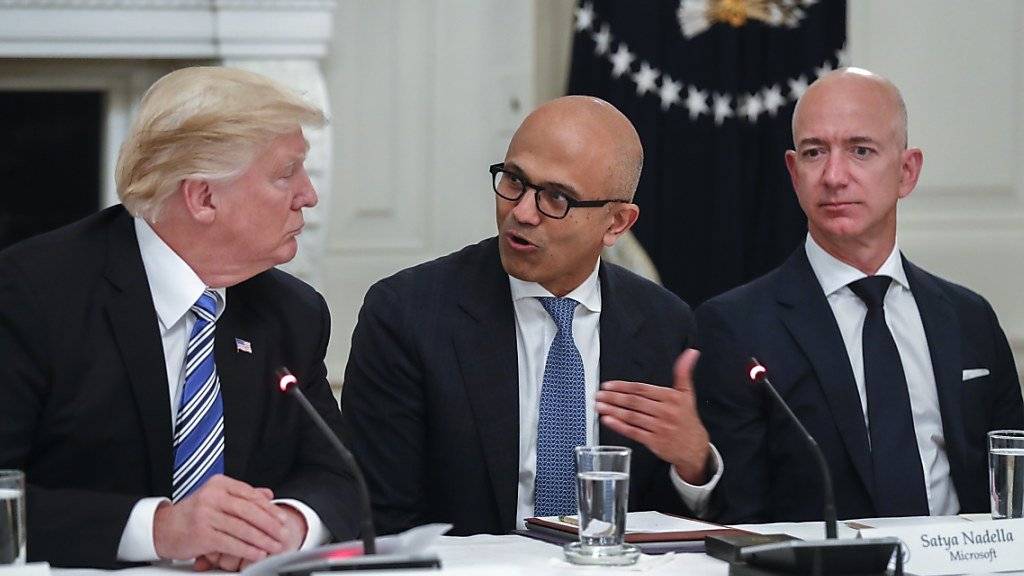 Mächtige aus Politik und Wirtschaft an einem Tisch: US-Präsident Trump hört sich an, was Microsoft-CEO Satya Nadella (Mitte) und Amazon-Chef Jeff Bezos zu berichten haben.