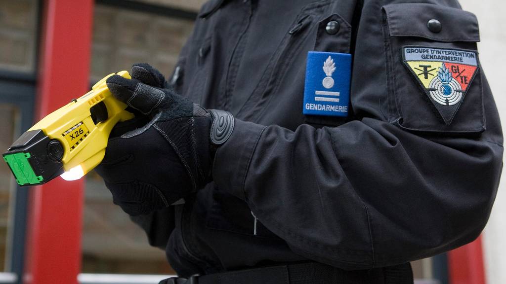 Ein Polizist in Genf mit einem Taser.