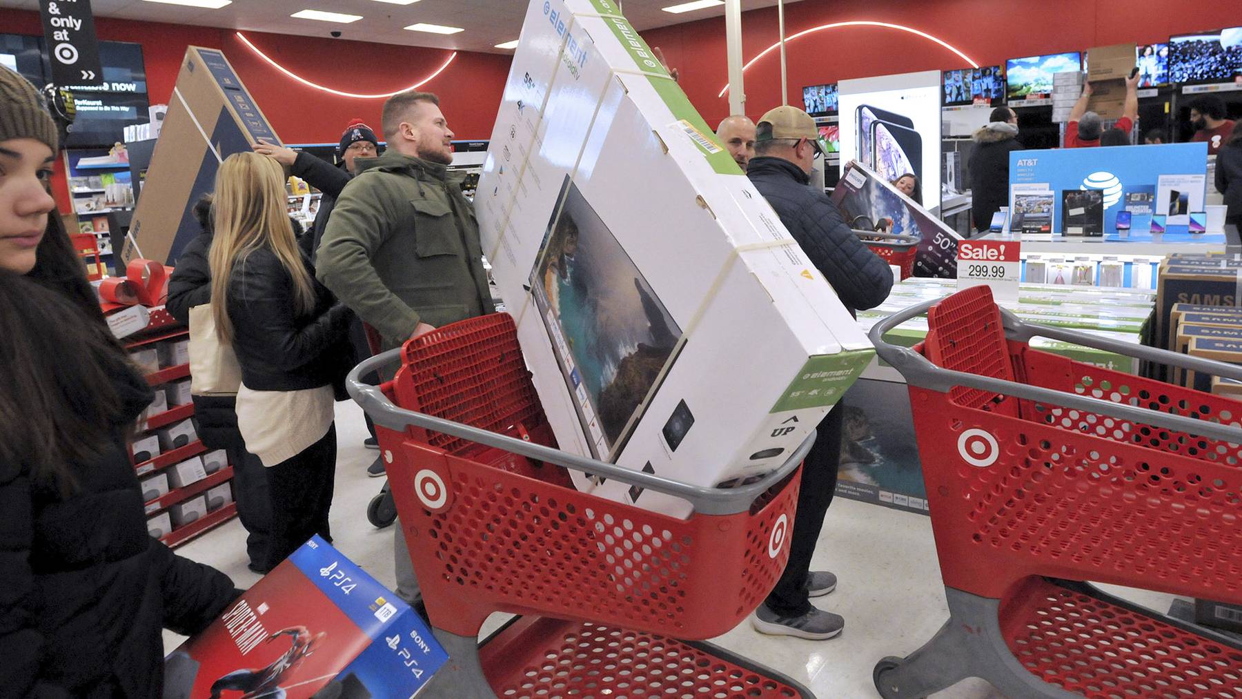 People look at the electronics section on Black Friday at a Target store in Plainville, Mass., Friday, Nov. 23, 2018.